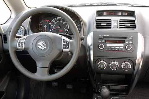 A tight cowl on the dashboard of the Suzuki SX4 Sport houses the instrument cluster with three overlapping circular gauges